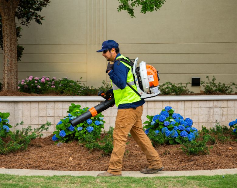 Landscaper using leafblower